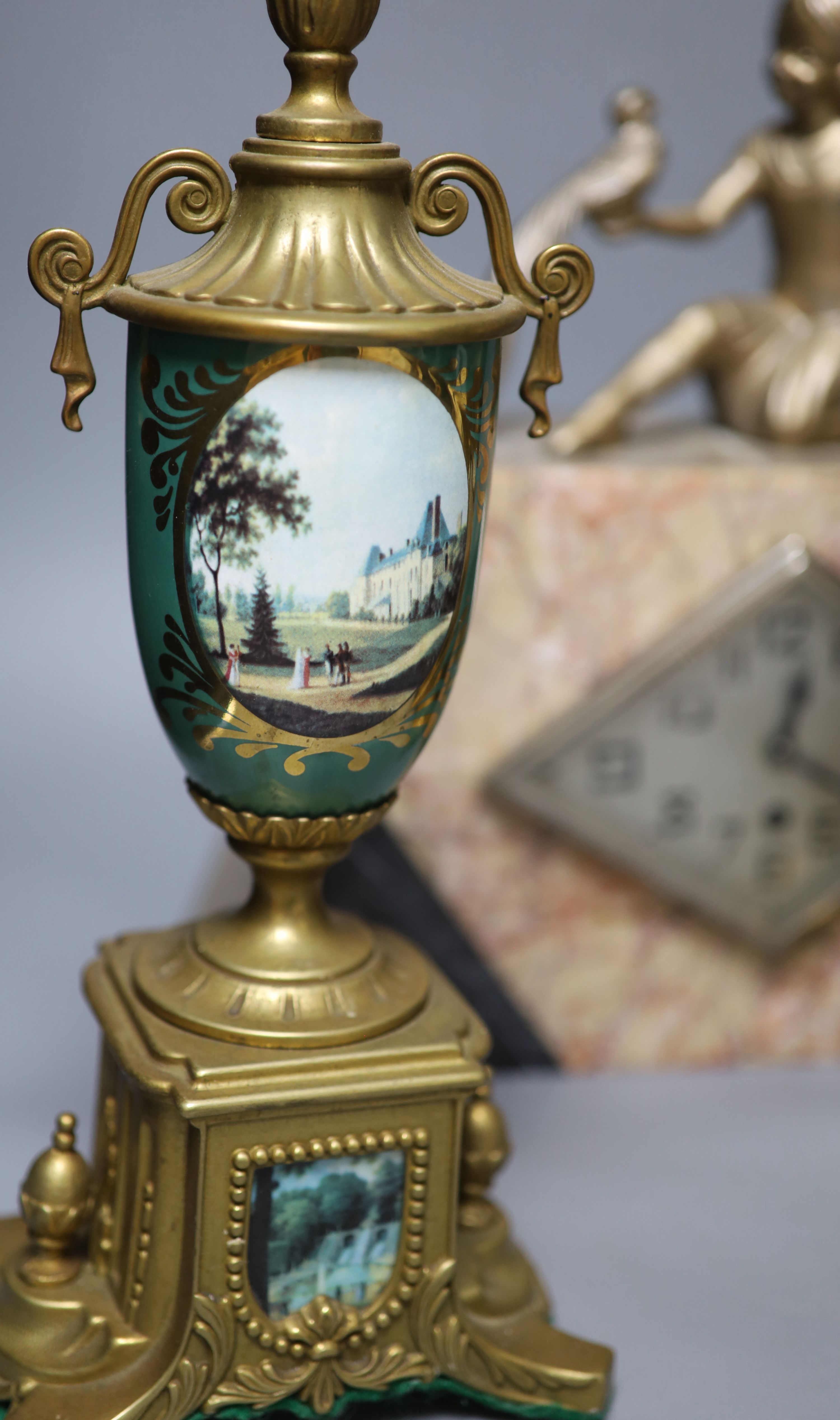 A Louis XV style gilt metal and porcelain three piece clock set and an Art Deco mantel clock, tallest 35cm